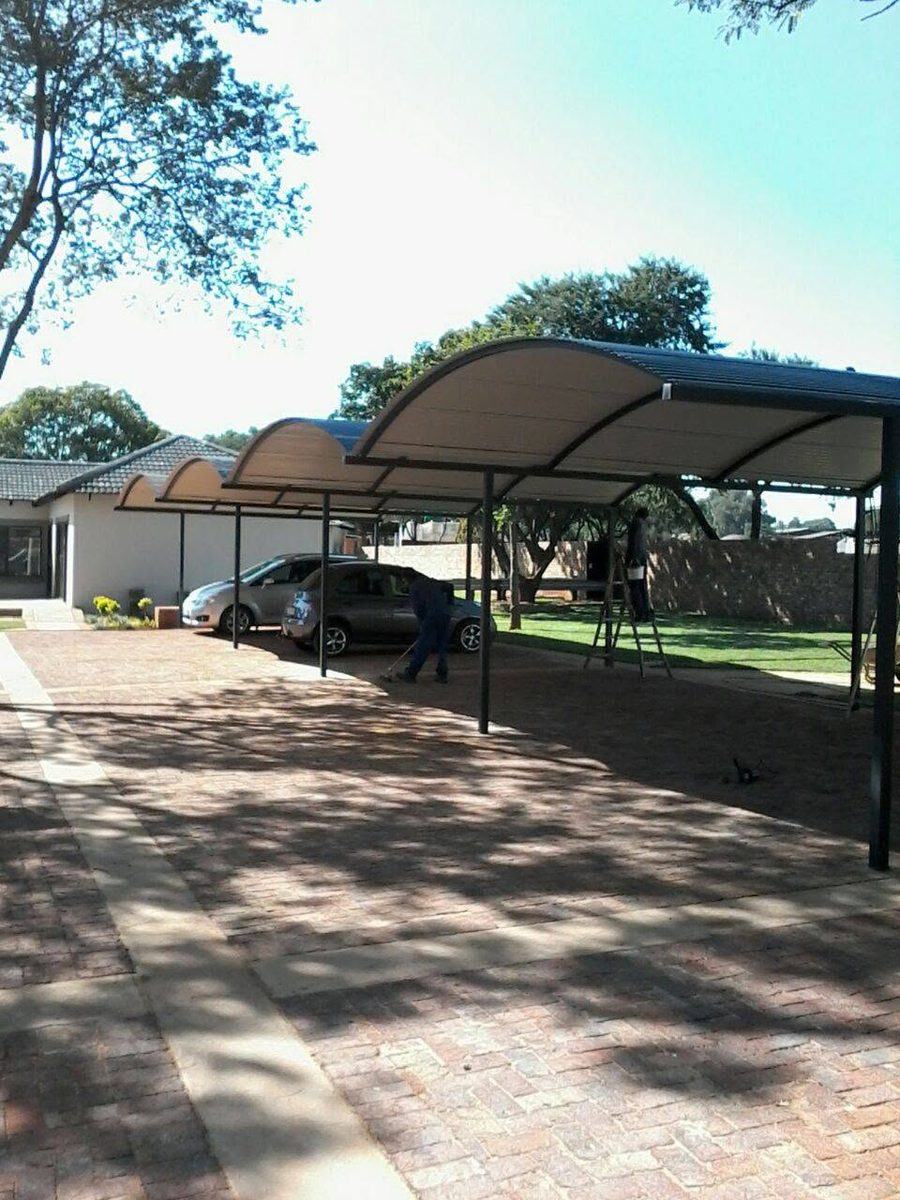 Curved steel carports over parking bays in Pretoria