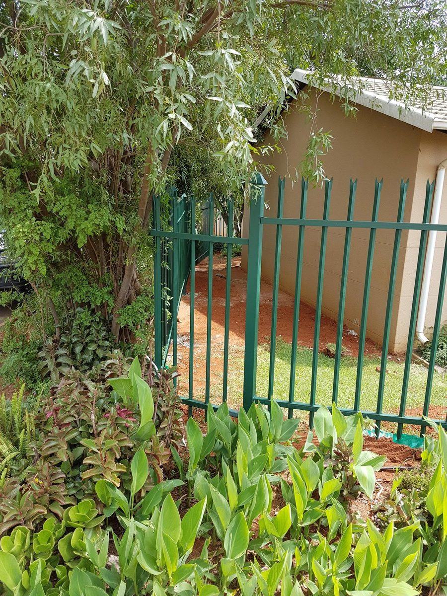 Green steel palisade fence and matching garden gate in Pretoria