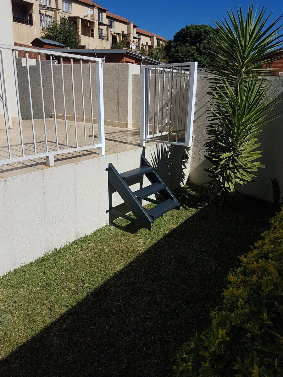 White palisade fence with pedestrian gate in Pretoria